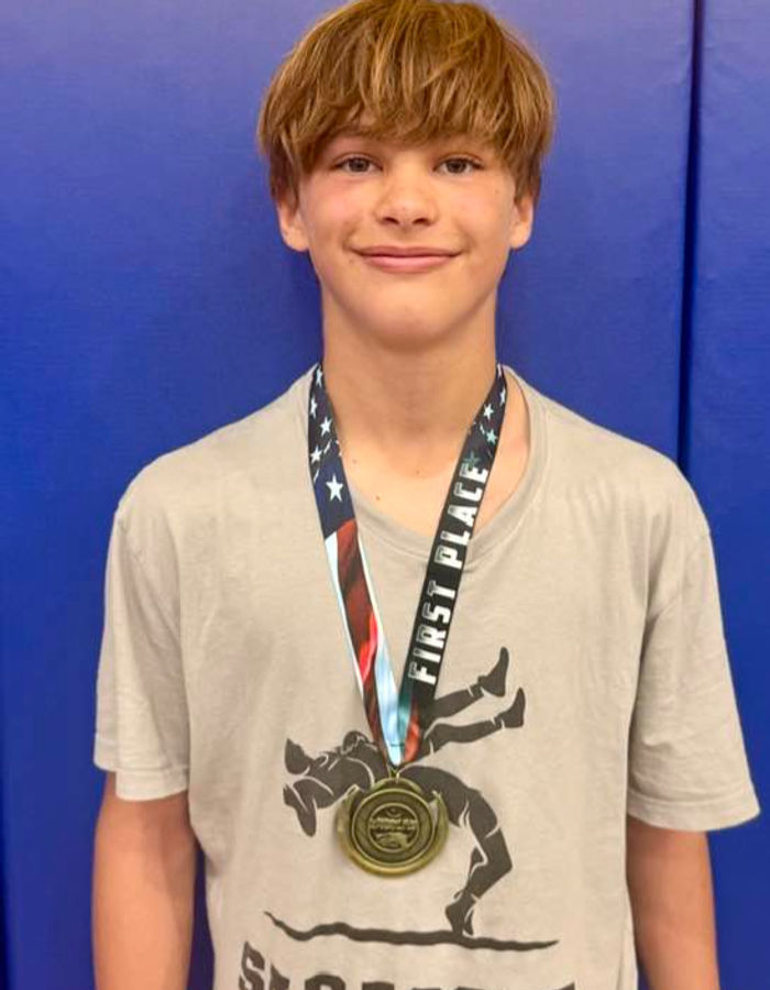 Max wearing his wrestling medal in Sarasota Wrestling Club gear