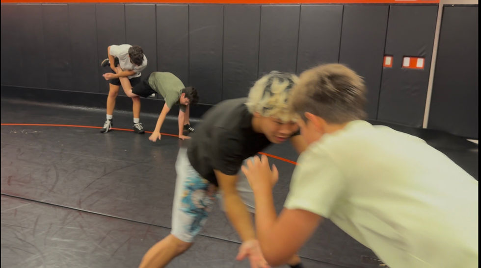 Youth wrestlers practicing takedowns at Sarasota Wrestling Club